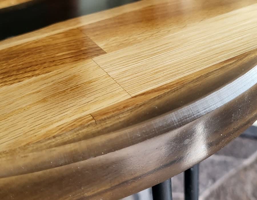 The oak and black resin table photographed in a room, on its black hairpin legs.